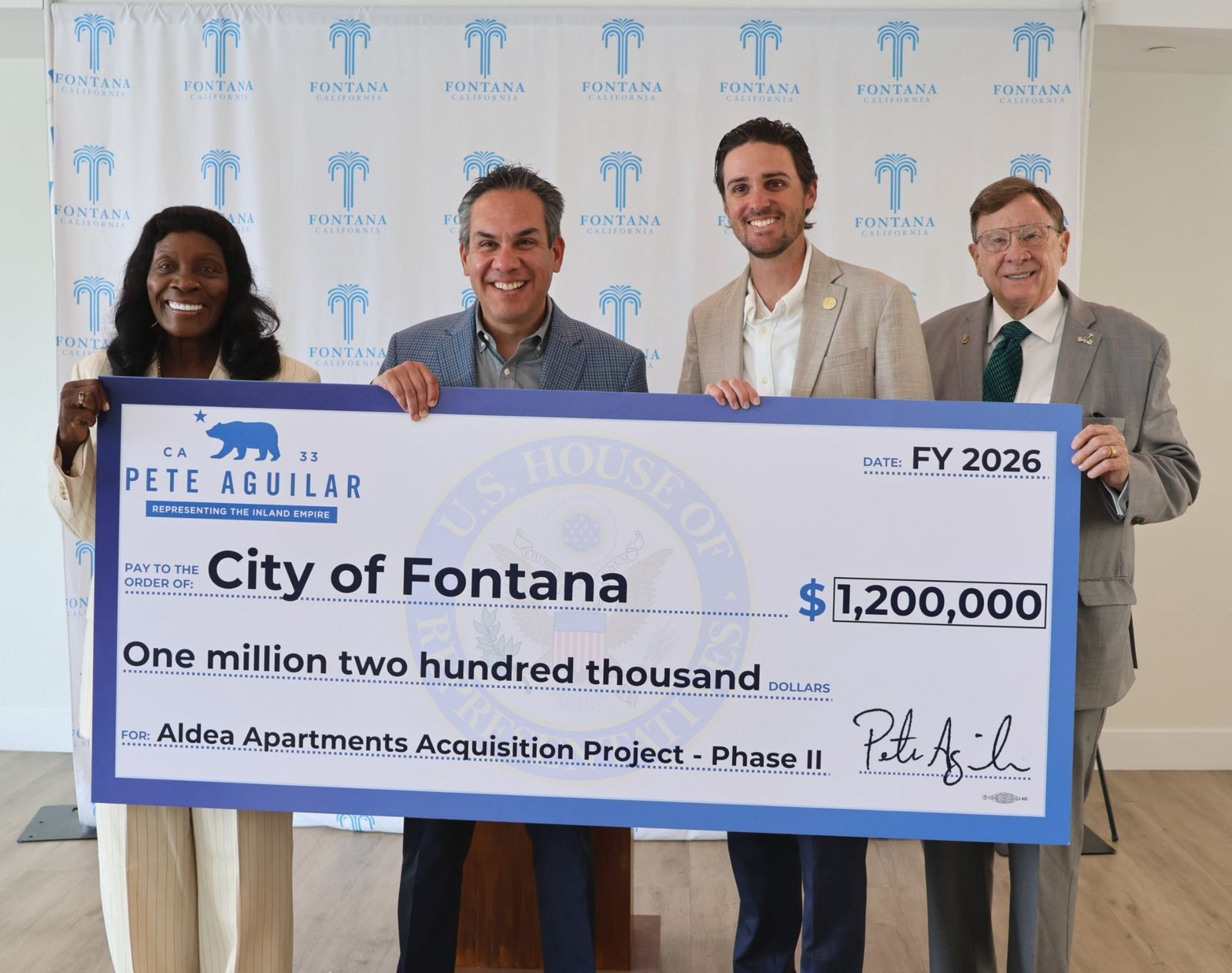 Rep. Pete Aguilar and Fontana officials hold a ceremonial check for the Aldea Apartments project.