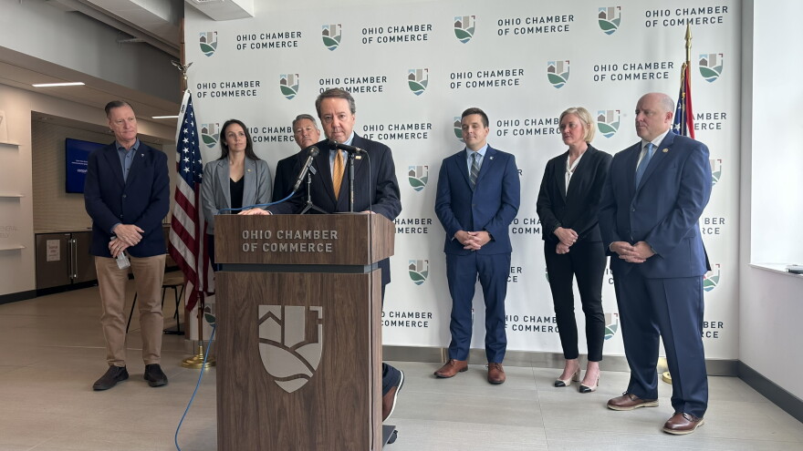 Ohio business leaders stand at a lectern with Supreme Court candidates Colleen O'Donnell and Dan Hawkins at an endorsement event.