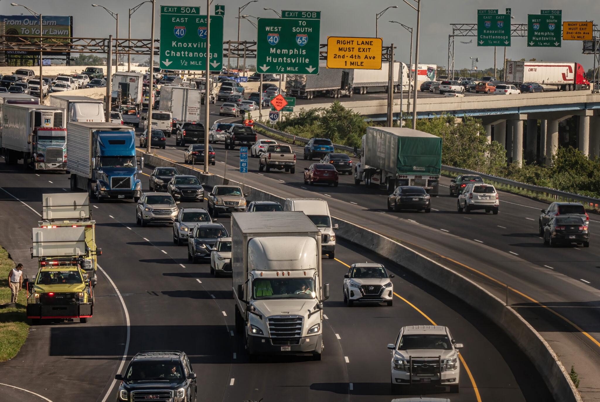 Cars and trucks travel through a Nashville interstate interchange.
