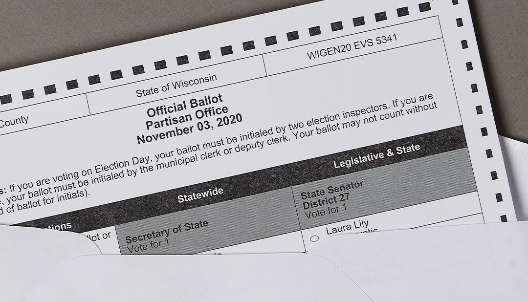 Wisconsin ballot dated November 3, 2020, partly inside an envelope; contextual historical voting photograph.